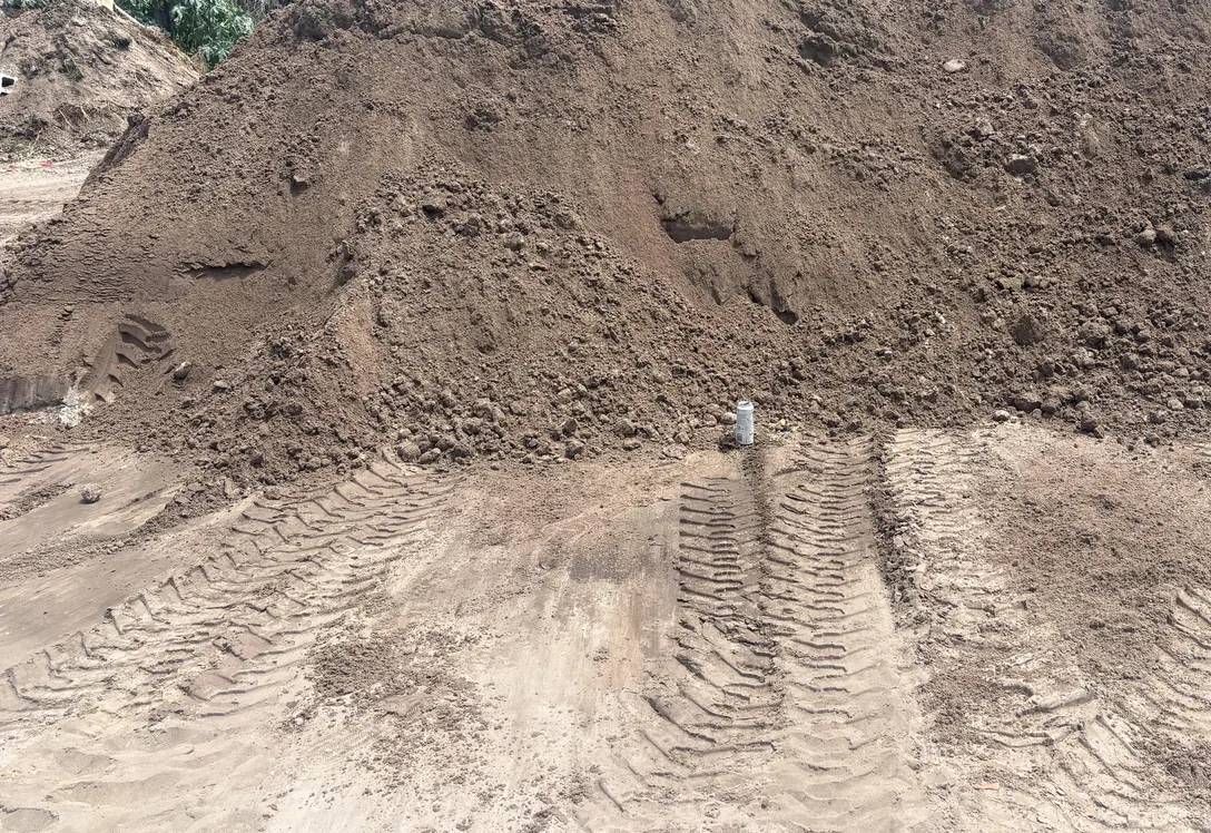 Large pile of delivered fill dirt dropped on a worked-up lot