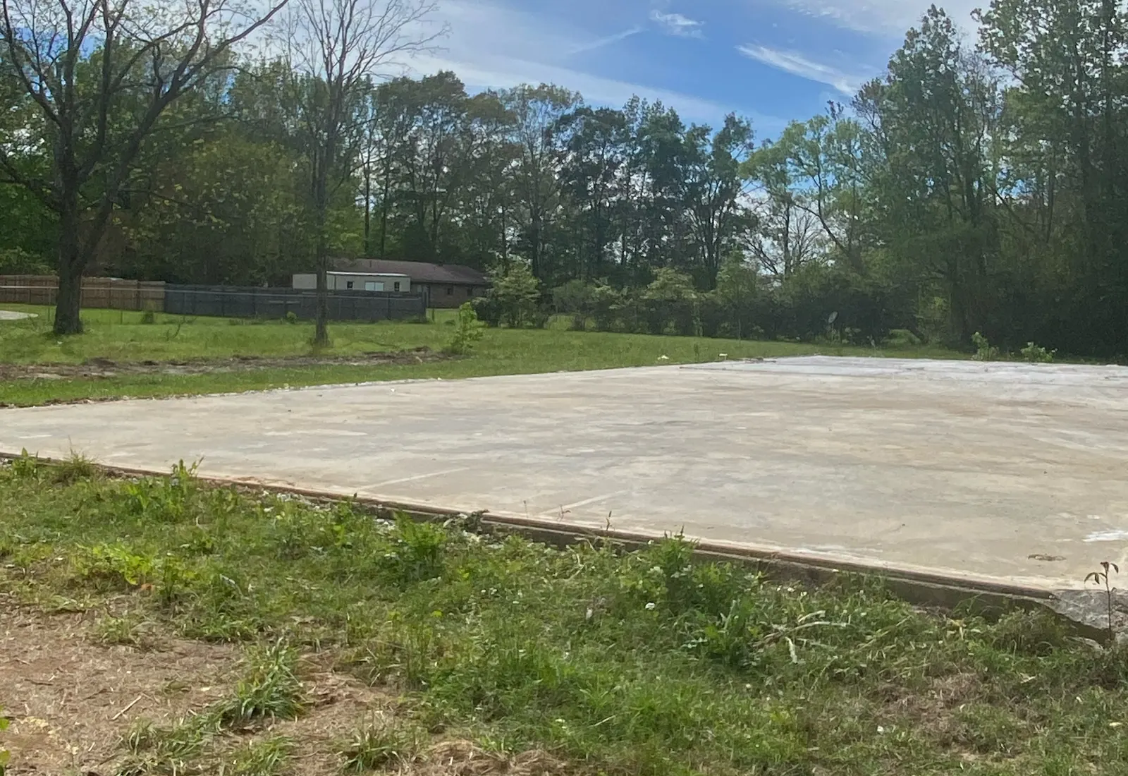 Concrete slab sitting on a raised dirt house pad on a north Louisiana lot