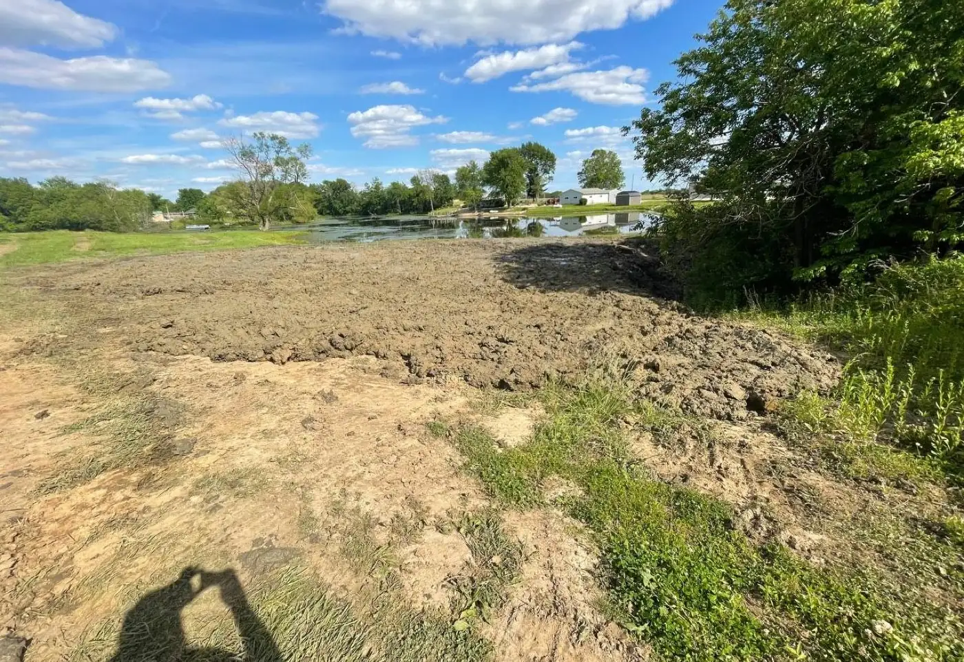 Silt and spoil pulled out of an old pond and piled on the bank during a cleanout